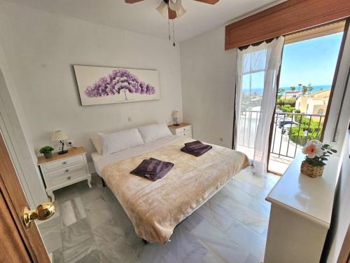 a bedroom with a bed and a large window at Apartamento SEA VIEW Celeste Costa del sol Playa Chapparal in Mijas Costa