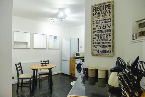 eine Küche mit einem Tisch und Stühlen im Zimmer in der Unterkunft Cosy Corner Cottage - Simple2let Serviced Apartments in Halifax