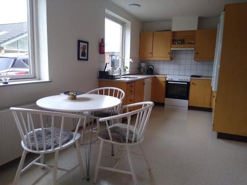 a kitchen with a table and two chairs and a table at 6 Room Holiday House, Private Garden, Lego House, Legoland, Lalandia, in Billund