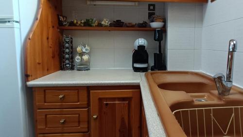 a small kitchen with a sink and a counter top at Portico Cozy Home in Kariá