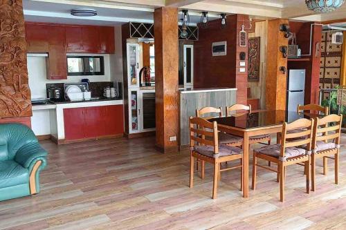 a kitchen and dining room with a table and chairs at Delia's Guest House in Mactan