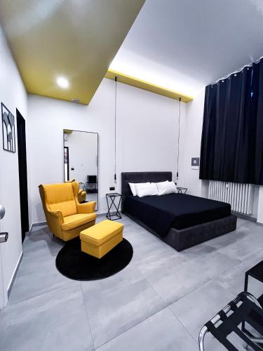 a bedroom with a bed and a couch and a chair at BeTurin in Turin