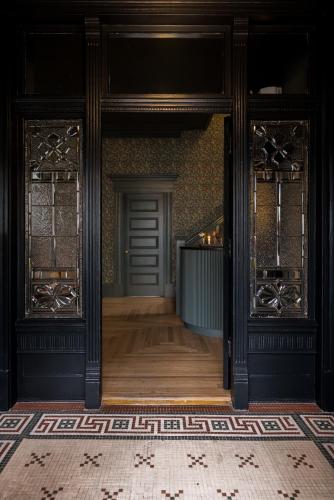 an entrance to a room with a door and a floor at Dvele Inn in St. John's
