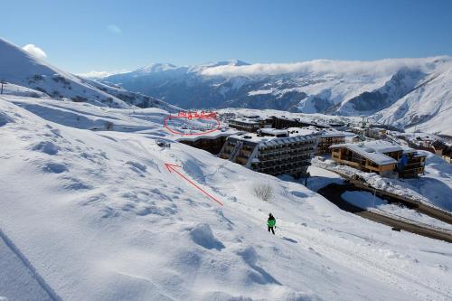 a person is skiing down a snow covered mountain at 2-room Apartment Gudauri Penta 703 in Gudauri