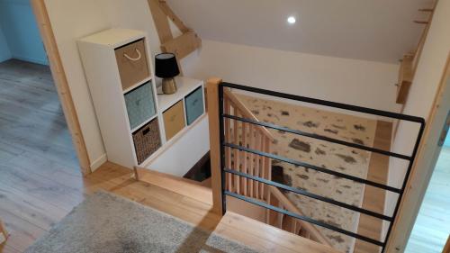 an image of a staircase in a house at Petite maison de campagne in La Bazoge