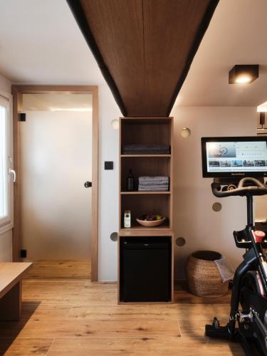 a room with a door and a television and a table at Hom Santorini in Oia