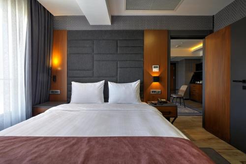 Ένα ή περισσότερα κρεβάτια σε δωμάτιο στο Nova Vista Deluxe & Suites a Member of Radisson Individuals