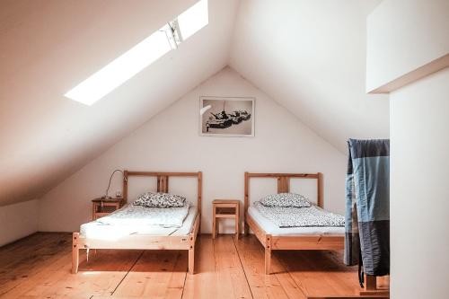 two beds in a room with a attic at Layer Residences in Kranj