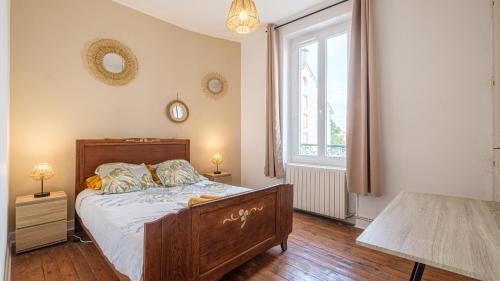 um quarto com uma cama e uma grande janela em Les Cheminées - Welc'Home em Limoges