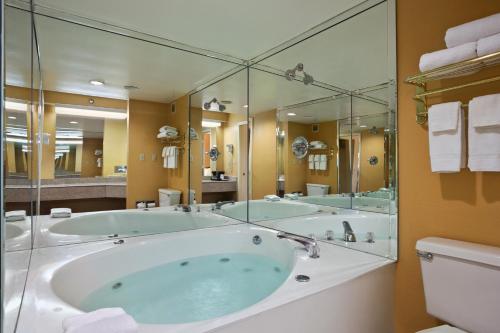 a large bathroom with a large tub and a toilet at Days Inn by Wyndham Airport Nashville East in Nashville