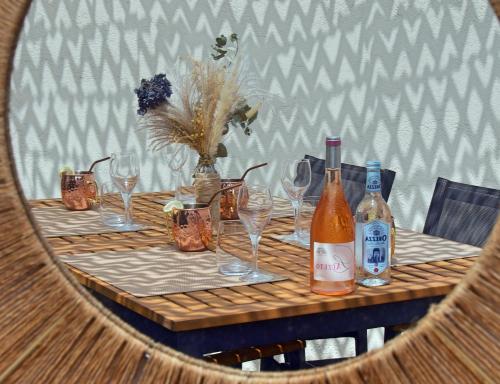 a table with glasses and bottles of wine on it at Résidence de la Tour in Piana
