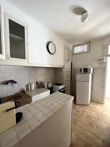 a kitchen with a refrigerator and a counter top at Le Pêcheur in Cassis