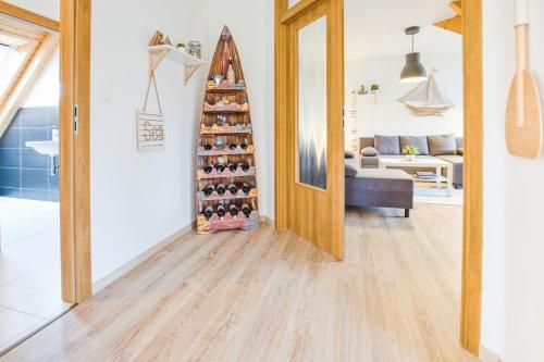 a room with a christmas tree in front of a door at Apartmán Riviéra Lipno 510/21 in Lipno nad Vltavou