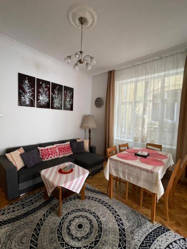 a living room with a couch and a table at Family Home in Budapest