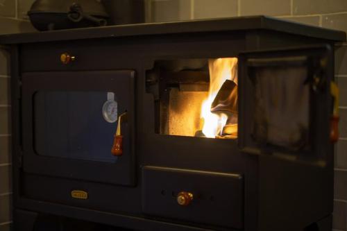 a stone oven with a fire in it at The Rumple Hut in Wingfield