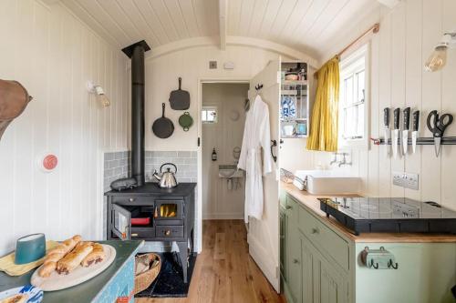 a kitchen with a sink and a stove in it at The Rumple Hut in Wingfield