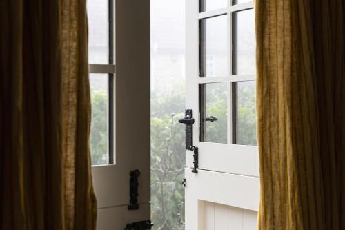 a window with a white door with a view at The Rumple Hut in Wingfield