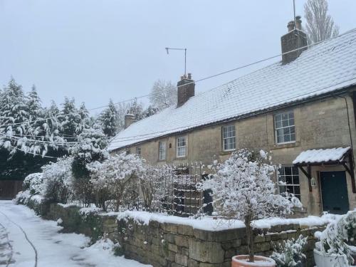 a brick house with snow on its roof at The Rumple Hut in Wingfield