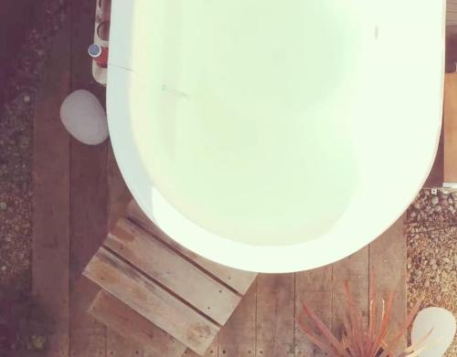 a round mirror on top of a wooden floor at The Rumple Hut in Wingfield