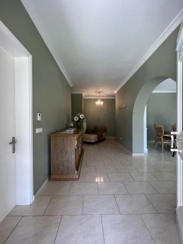 a hallway with an archway and a living room at Villa Alexakis Doukades in Doukádes