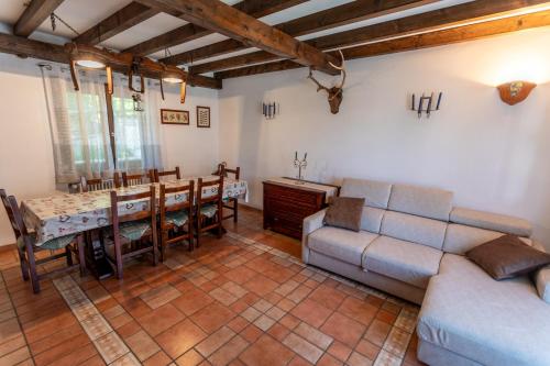 a living room with a couch and a table at Casa vacanze “Le noci” in SantʼEufemia a Maiella