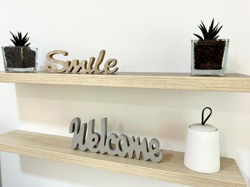 a shelf with plants and a smile melon sign at Creekside House K in Mozirje