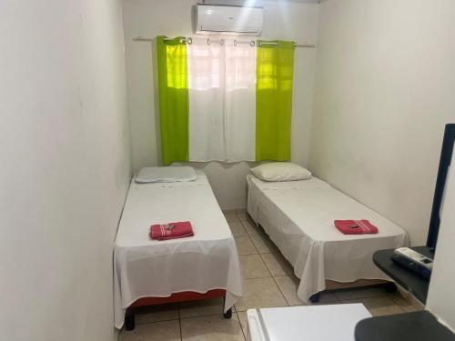 Katil atau katil-katil dalam bilik di Sobradinho Hotel