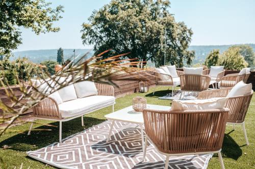 a group of chairs and tables on the grass at Hôtel Le Romantica in Pennedepie