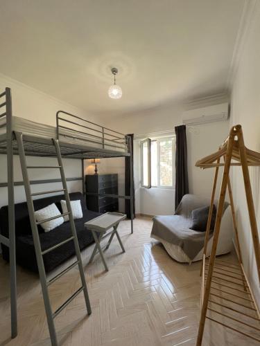 a bedroom with two bunk beds and a desk at Villa Alexakis Doukades in Doukádes