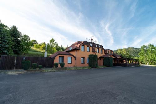 a large brown house with a fence and a road at Formule in Pürstein