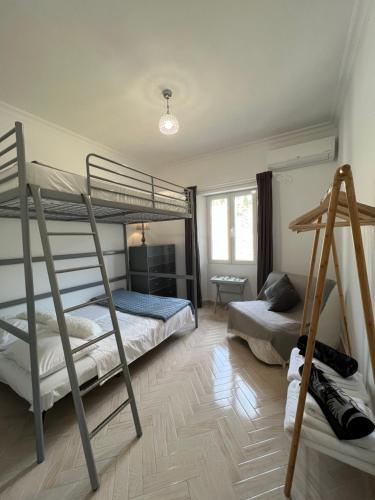 a bedroom with two bunk beds and a desk at Villa Alexakis Doukades in Doukádes