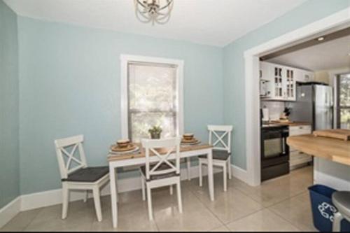 a dining room with a table and chairs and a kitchen at St Petersburg Vacation Rentals in St Petersburg