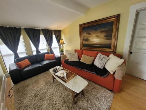 a living room with a couch and a table at St Petersburg Vacation Rentals in St Petersburg