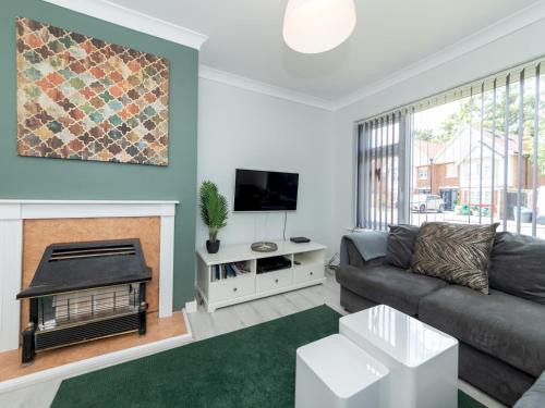 a living room with a couch and a fireplace at 2BDR Peaceful Ground Floor Apartment Free Parking - Pass the Keys in Wokingham
