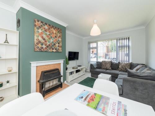 a living room with a couch and a fireplace at 2BDR Peaceful Ground Floor Apartment Free Parking - Pass the Keys in Wokingham