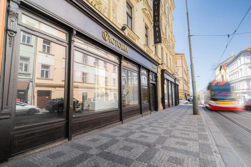 a building with windows on a street with a bus at EA Hotel Victoria in Prague