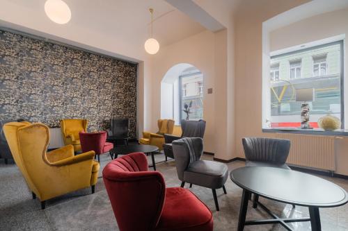 a waiting room with chairs and tables at EA Hotel Victoria in Prague