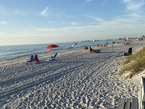 a group of people on a beach with the ocean at St Petersburg Vacation Rentals in St Petersburg