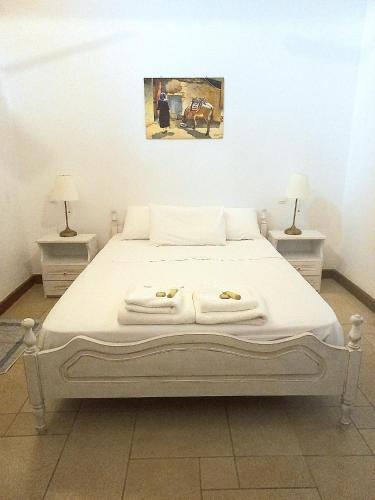 a bedroom with a bed with two towels on it at Platanos in Vasiliki