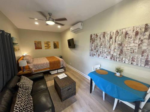 a living room with a bed and a blue table at St Petersburg Vacation Rentals in St Petersburg