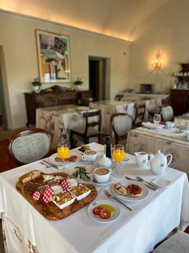 a white table with food and drinks on it at Hotel Boutique Molino del Arco in Ronda