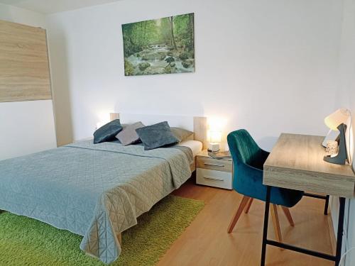 a bedroom with a bed and a desk and a table at Apartmaji Sofia in Maribor