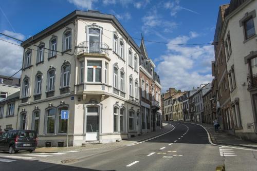a white building on the side of a street at Entre Deux Pays Apartments in Spa