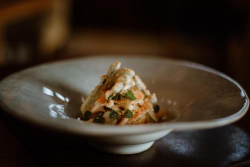 a piece of food in a white bowl on a table at Links House at Royal Dornoch in Dornoch