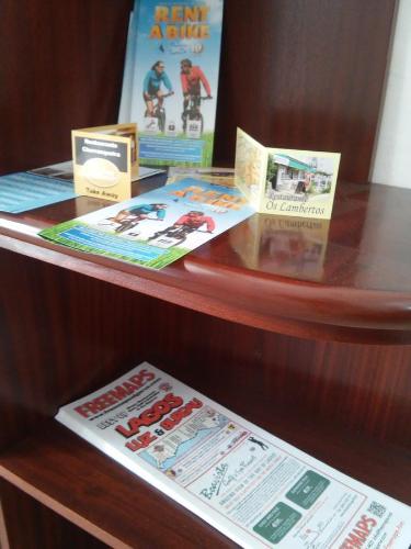 a display case with books on a wooden shelf at White Sun Hostel in Lagos