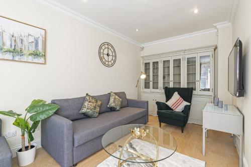 a living room with a couch and a glass table at Fabulous House near the Science Museum in London