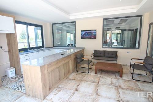 a kitchen with a large island in a living room at Sea Pearl flat in Avsallar