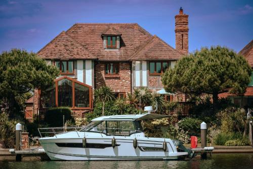 a white boat docked in front of a house at Wellington Quay in Eastbourne