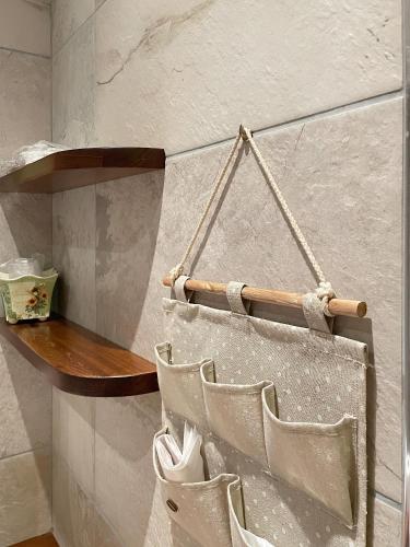 a wall with a wooden shelf and some chairs at La Rocca in Carrù