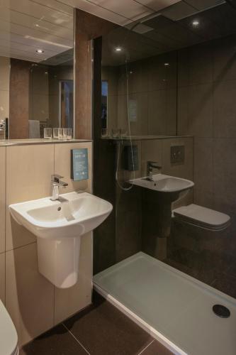 a bathroom with a sink and a shower and a toilet at Invercarse Hotel Dundee, BW Signature Collection in Dundee